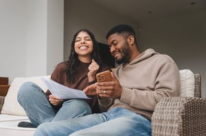 Smiling couple looking at smartphone together