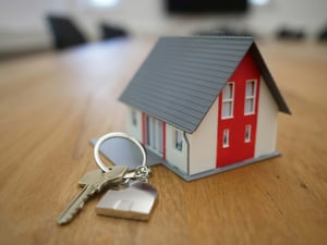 A model house next to a set of house keys